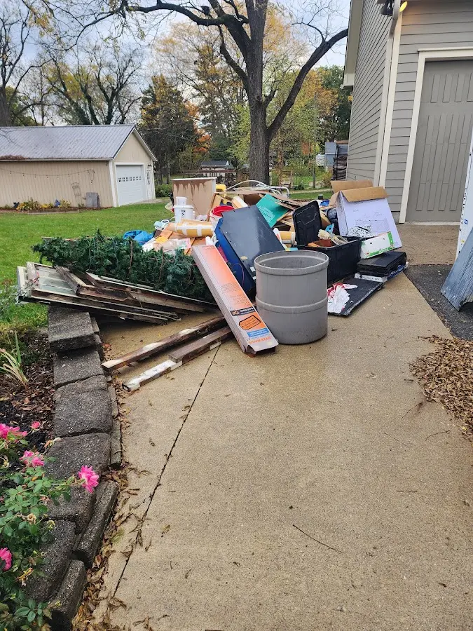 Dumpster being loaded with debris for Roofing Dumpster Rental in Druid Hills